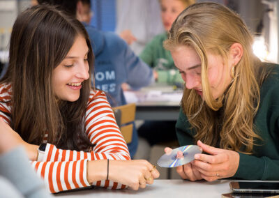 students investigating the reflections of a compact disc