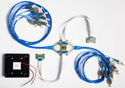 PHIX Characterization Package with fanout boards, fiber arrays, and cooling carrier.