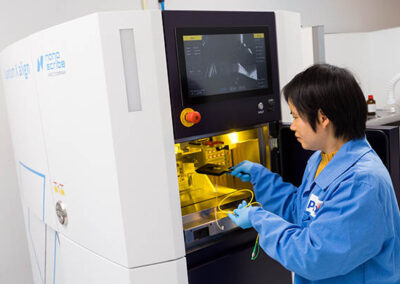 Loading a fiber array into the Nanoscribe Quantum X align machine for 3D printing of microlenses.