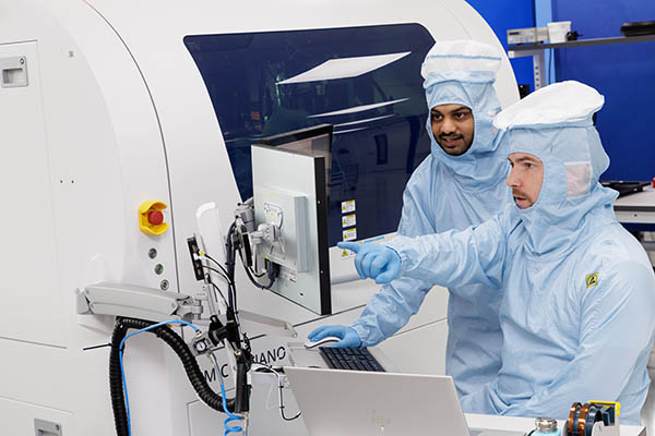Manufacturing engineers setting up a semiconductor assembly process