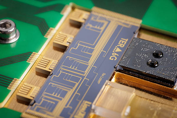 Ten gain chips, grouped in arrays, edge coupled to a SiN PIC in the TERA6G receiver laser module
